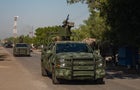 A convoy of vehicles from the Mexican army are seen on patrol in Aguililla, Mexico, on April 23, 2021. Aguililla was being threatened due to the confrontation of organized crime groups called the Jalisco Nueva Generacion Cartel, or CJNG, and the Michoacan 