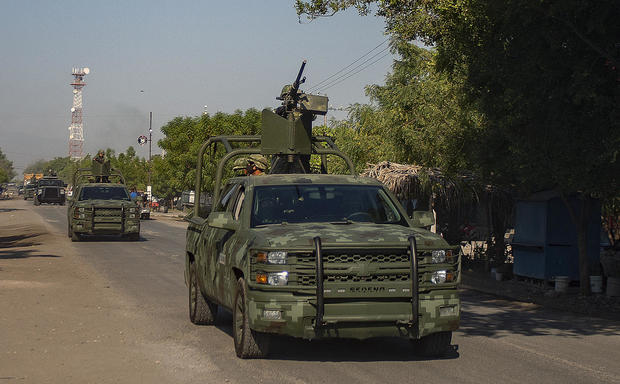 A convoy of vehicles from the Mexican army are seen on patrol in Aguililla, Mexico, on April 23, 2021. Aguililla was being threatened due to the confrontation of organized crime groups called the Jalisco Nueva Generacion Cartel, or CJNG, and the Michoacan Family, now called Viagras. 