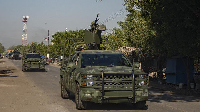 A convoy of vehicles from the Mexican army are seen on patrol in Aguililla, Mexico, on April 23, 2021. Aguililla was being threatened due to the confrontation of organized crime groups called the Jalisco Nueva Generacion Cartel, or CJNG, and the Michoacan 