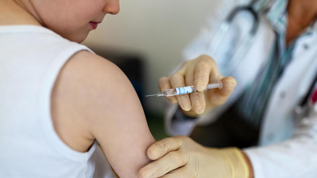 Boy getting a flu or coronavirus vaccine in the clinic 