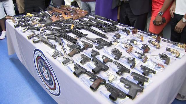 A table full of guns at a buyback event in Harlem 