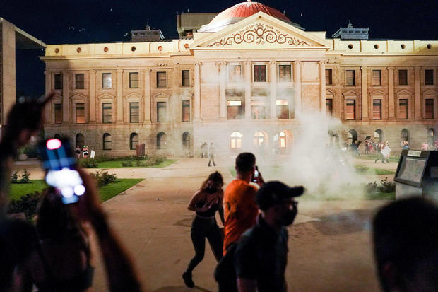 Arizona state troopers deploy tear gas as they confront abortion rights protesters 