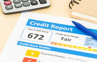 Fair credit score report with pen and calculator; document and the report are mocked-up 