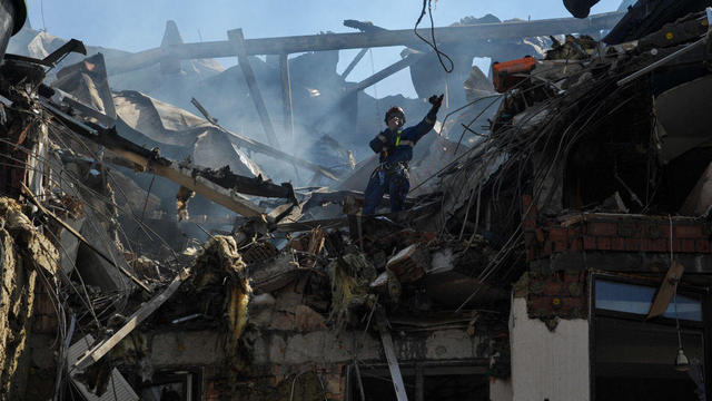 Rescuers work on a damaged residential building, as a result 