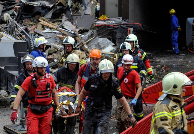 Rescuers carry an injured person who suffered as a result of 