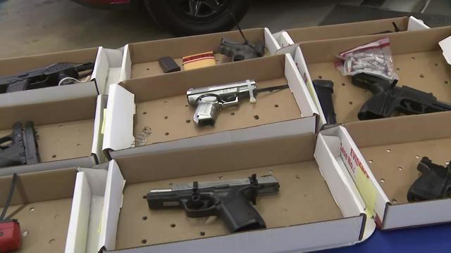 Guns confiscated at Newark Liberty International Airport security checkpoints are on display on a table 