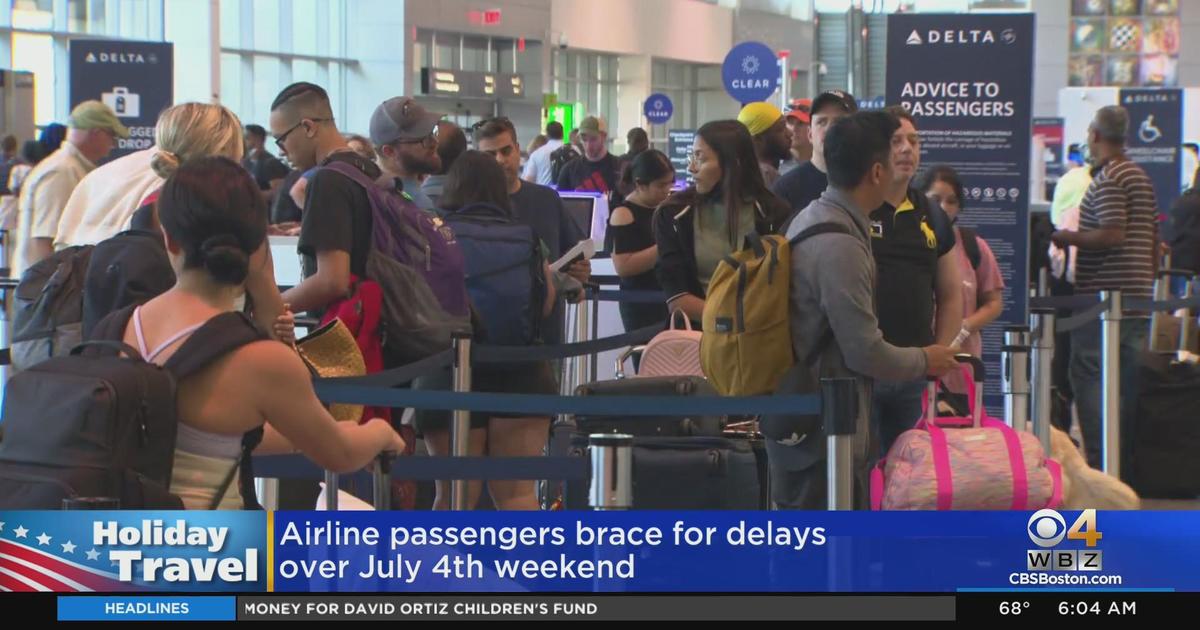 Travelers line up at Logan Airport ahead of holiday weekend