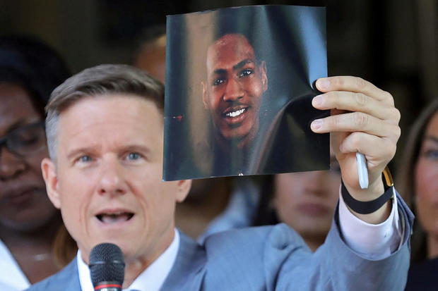 Attorney Bobby DiCello holds up a photograph of Jayland Walker as he speaks on behalf of the Walker family during a press conference in Akron, Ohio, on June 30, 2022. 