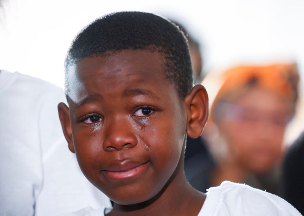 A boy reacts during a mass funeral for victims of an east coast tavern where bodies of youth were found which prompted nationwide grief, in the Eastern Cape province, in East London, South Africa, July 6, 2022.