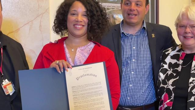 Teacher Lizandaa Alburg holds a proclamation after being named Middle School Teacher of the Year by National History Day 