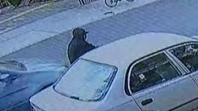 Surveillance video shows a blue minivan very close behind a man on a cyclist. 