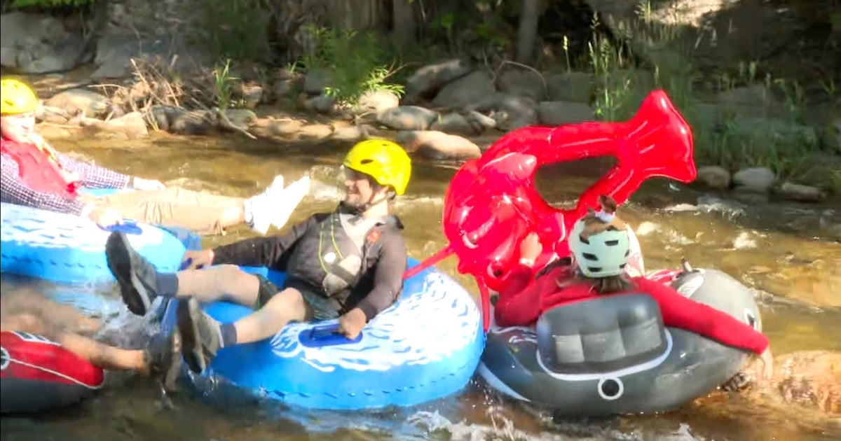 Welldressed commuters brave the rapids of Boulder Creek on quirky Tube