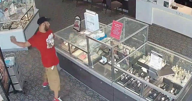 Man tries to smash jewelry case with a brick - CBS News