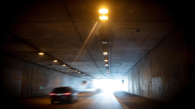 Photo with movement at the exit of a tunnel. There is some traffic. 