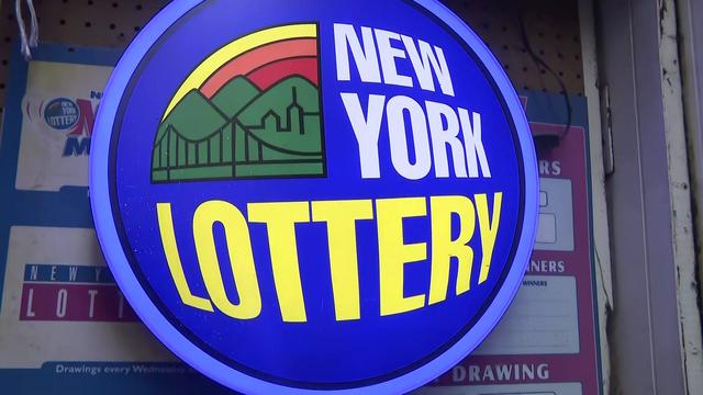 A sign with the New York Lottery logo 