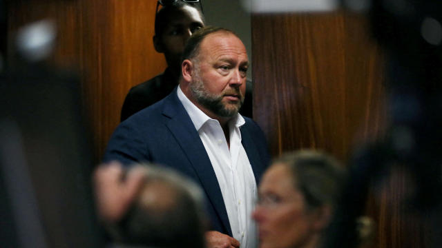 FILE PHOTO: Alex Jones walks into the courtroom in front of parents of 6-year-old Sand Hook shooting victim Jesse Lewis in Austin 