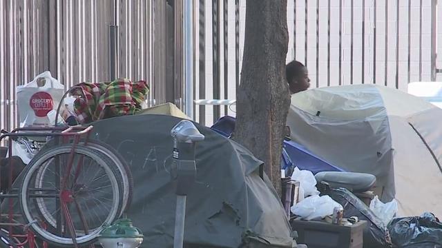 Photo of homeless encampment on sidewalk in Sacramento. 