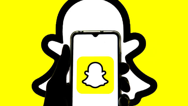 In this photo illustration a Snapchat logo seen displayed on 