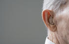 Close up of senior Hispanic manÂ¿s hearing aid 