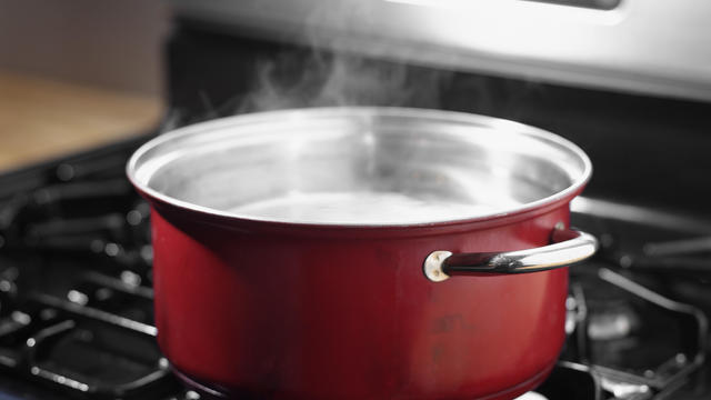 Pot of boiling water on stove top 