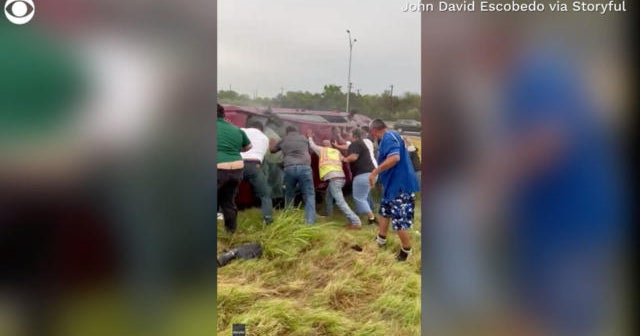 Good Samaritans flip car after rollover crash - CBS News