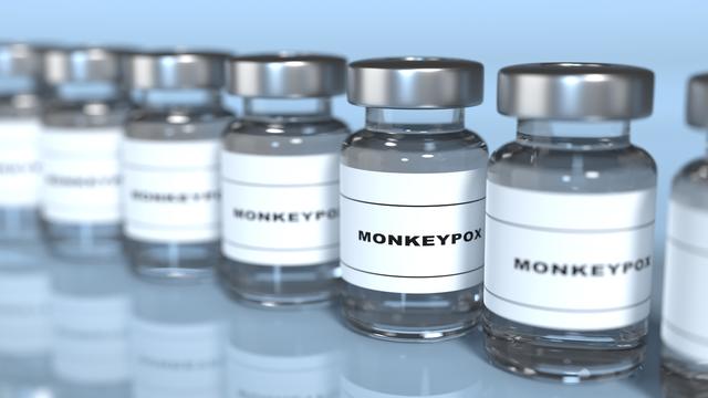 Line of Monkeypox Vaccines on Blue Shiny Background 