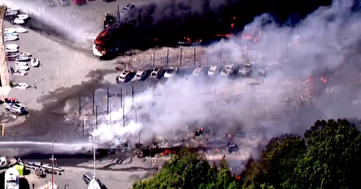 Large fire rips through Massachusetts boatyard, destroying boats and cars