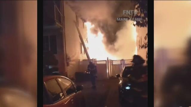 Flames can be seen coming from a home. 