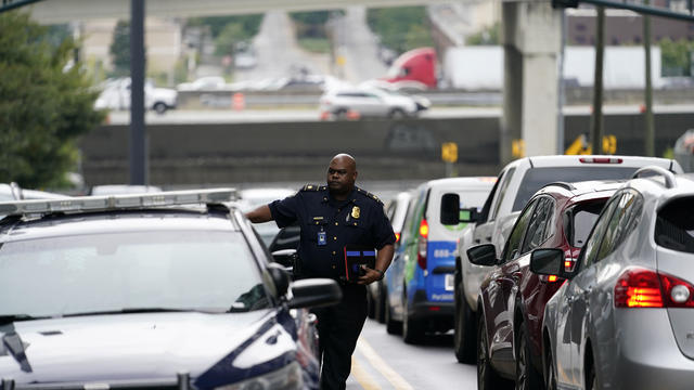 A police officer arrives on scene after a shooting occurred Aug. 22, 2022, at a condominium in Atlanta. 