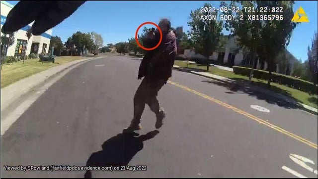 This is a screenshot from the body camera of a Fairfield police officer showing a suspect point a gun at them. 