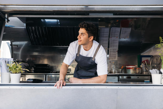 Full Length Of Young Man Standing In Kitchen food truck 