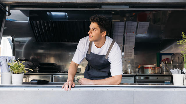 Full Length Of Young Man Standing In Kitchen food truck 