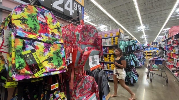 Backpacks and other school supplies are on display in a store.