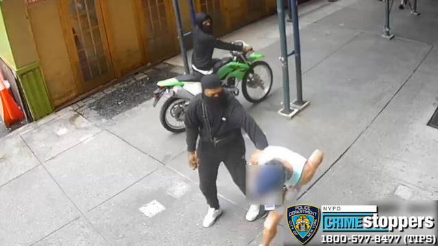 Surveillance video shows two men on a dirt bike accused of robbing another man in Chelsea. 