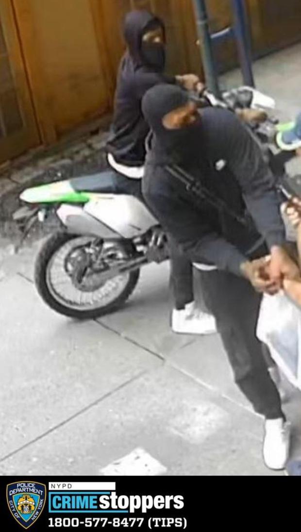 Surveillance video shows two men on a dirt bike accused of robbing another man in Chelsea. 