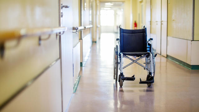 Empty wheelchair in hospital corridor 