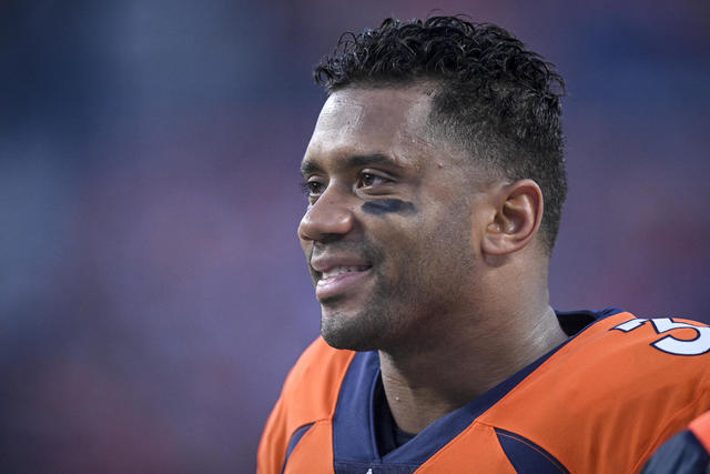 Denver Broncos quarterback Russell Wilson (3) is greeted by his 5-year-old  daughter Sienna, second from left, as stepson Future, left, son Win, third  from left, and wife, rap star Ciara, right, look on as he heads to the  playing field to take part in d