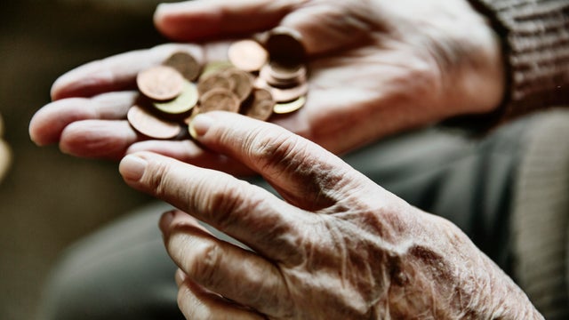 Senior woman's hands with coins 