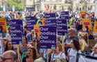 Pro-choice protesters hold "Our bodies, our choice" placards 