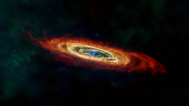 The Andromeda galaxy, or M31, is shown here in far-infrared and radio wavelengths of light. Some of the hydrogen gas (red) that traces the edge of Andromeda's disc was pulled in from intergalactic space, and some was torn away from galaxies that merged with Andromeda far in the past. The image is composed of data from the European Space Agency (ESA) Herschel mission, supplemented with data from ESA's retired Planck observatory and two retired NASA missions: the Infrared Astronomy Survey and Cosmic Background Explorer, as well as the Green Bank Telescope, WRST, and IRAM radio telescopes. 