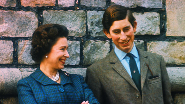 Prince Charles and Queen Elizabeth Standing by Wall 