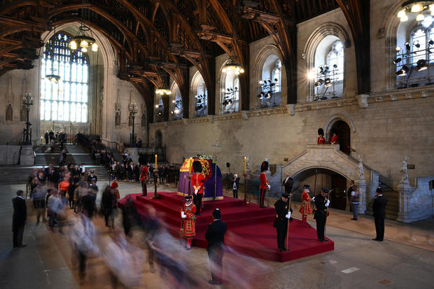 Members of the public pay their respects as they pass the coffin of Queen Elizabeth II as it lies in state inside Westminster Hall, at the Palace of Westminster in London on September 17, 2022. 