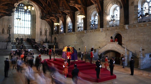 Members of the public pay their respects as they pass the coffin of Queen Elizabeth II as it lies in state inside Westminster Hall, at the Palace of Westminster in London on September 17, 2022.