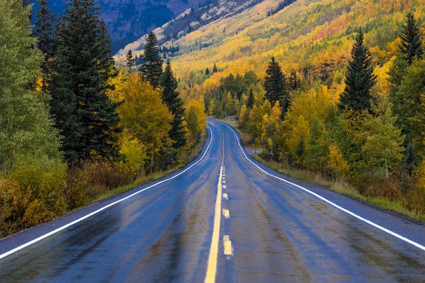 Wet autumn road goes from Ouray to Silverton Colorado, the Million Dollar Highway with color, Route 550 