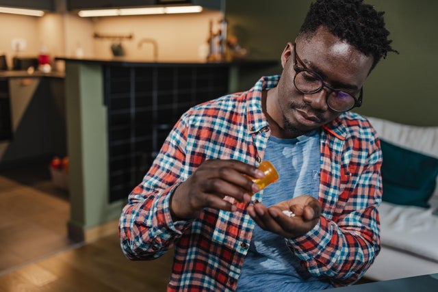 Young man taking medicine 