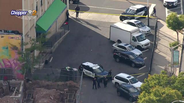 Crime scene tape blocks off a parking lot outside a building in Newark. 