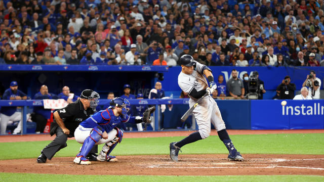Aaron Judge #99 of the New York Yankees hits his 61st home run of the season in the seventh inning against the Toronto Blue Jays at Rogers Centre on September 28, 2022 in Toronto, Ontario, Canada. 