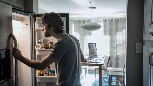 Man checks refrigerator 