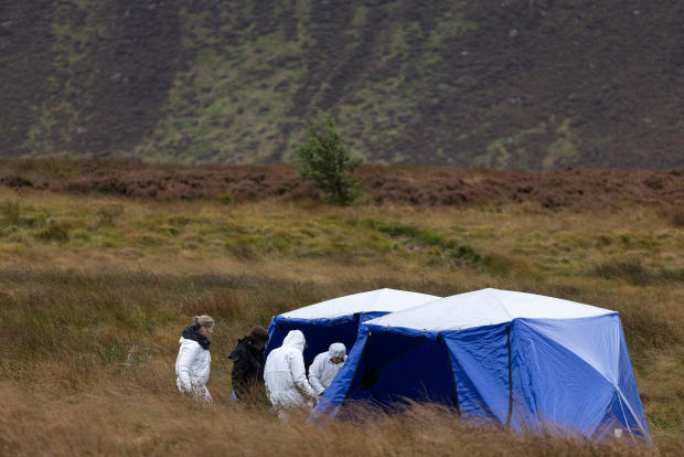 Police search the area of Saddleworth Moor after reports of a skull being found regarding the Moors murder investigations 