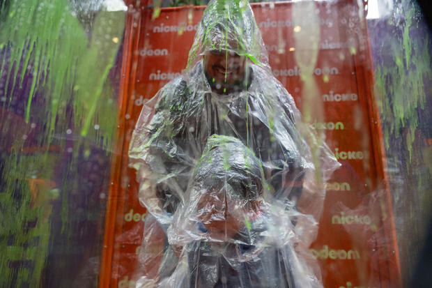People get 'slimed' at a Nickelodeon booth at PaleyWKND outside the Paley Museum on October 01, 2022 in New York City. 